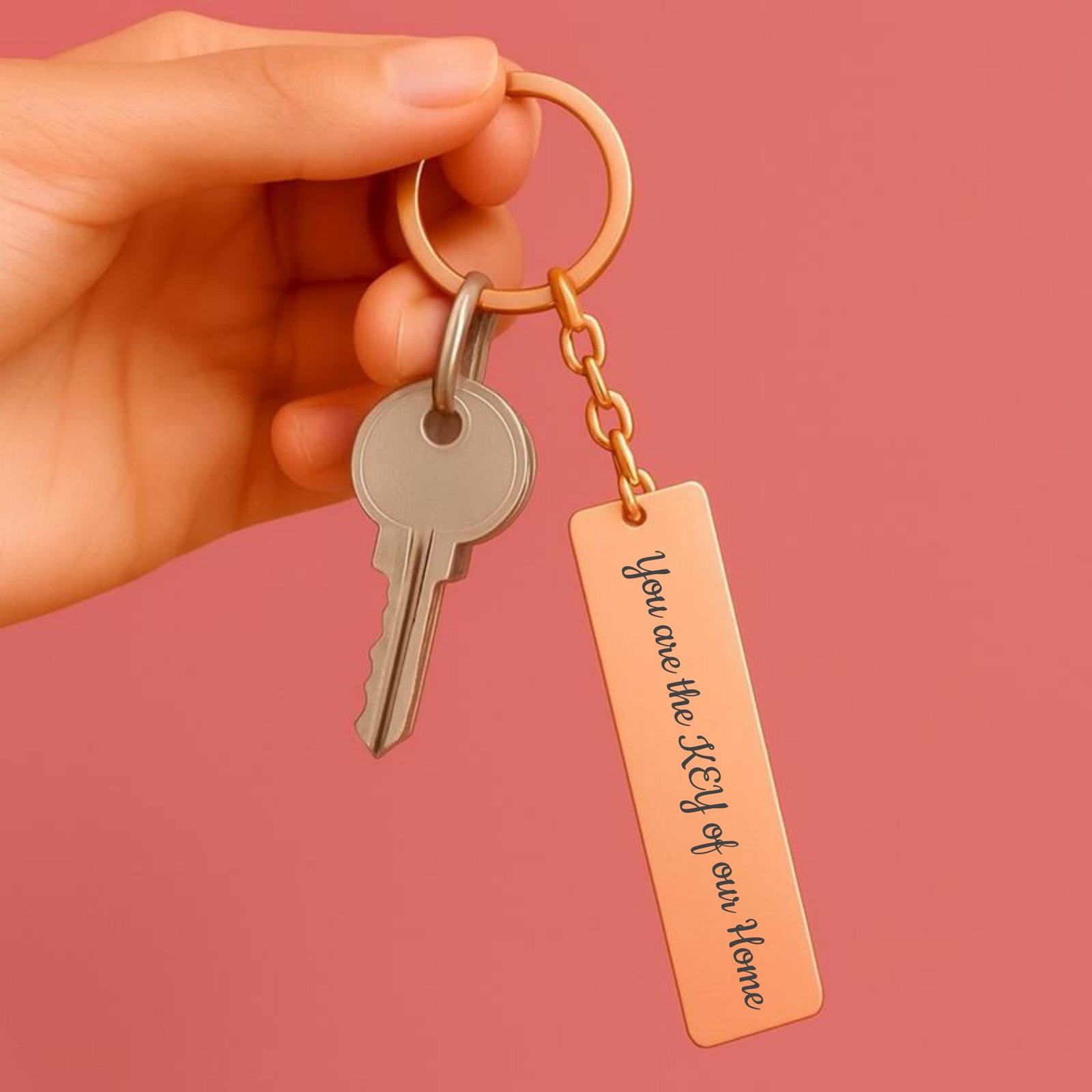 Hand holding personalized message keychain rose gold stainless steel custom engraved keychain with keys
