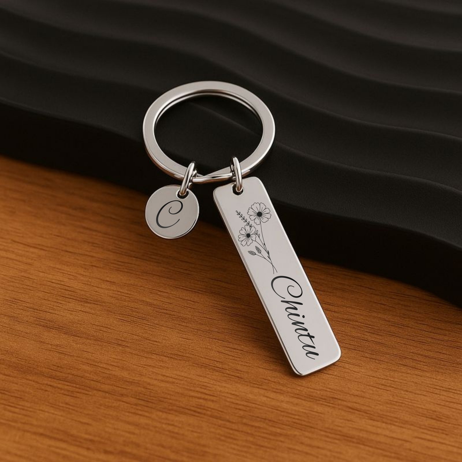 personalized engraved name keychain stainless steel silver floral design custom name engraving close up