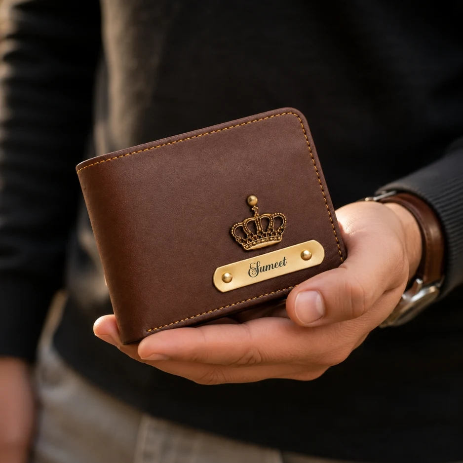 Personalized brown leather wallet with engraved name plate held in hand