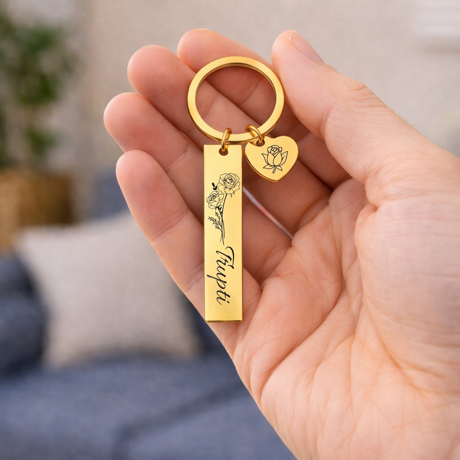 Personalized gold metal name keychain with engraving held in hand showing real size and premium finish