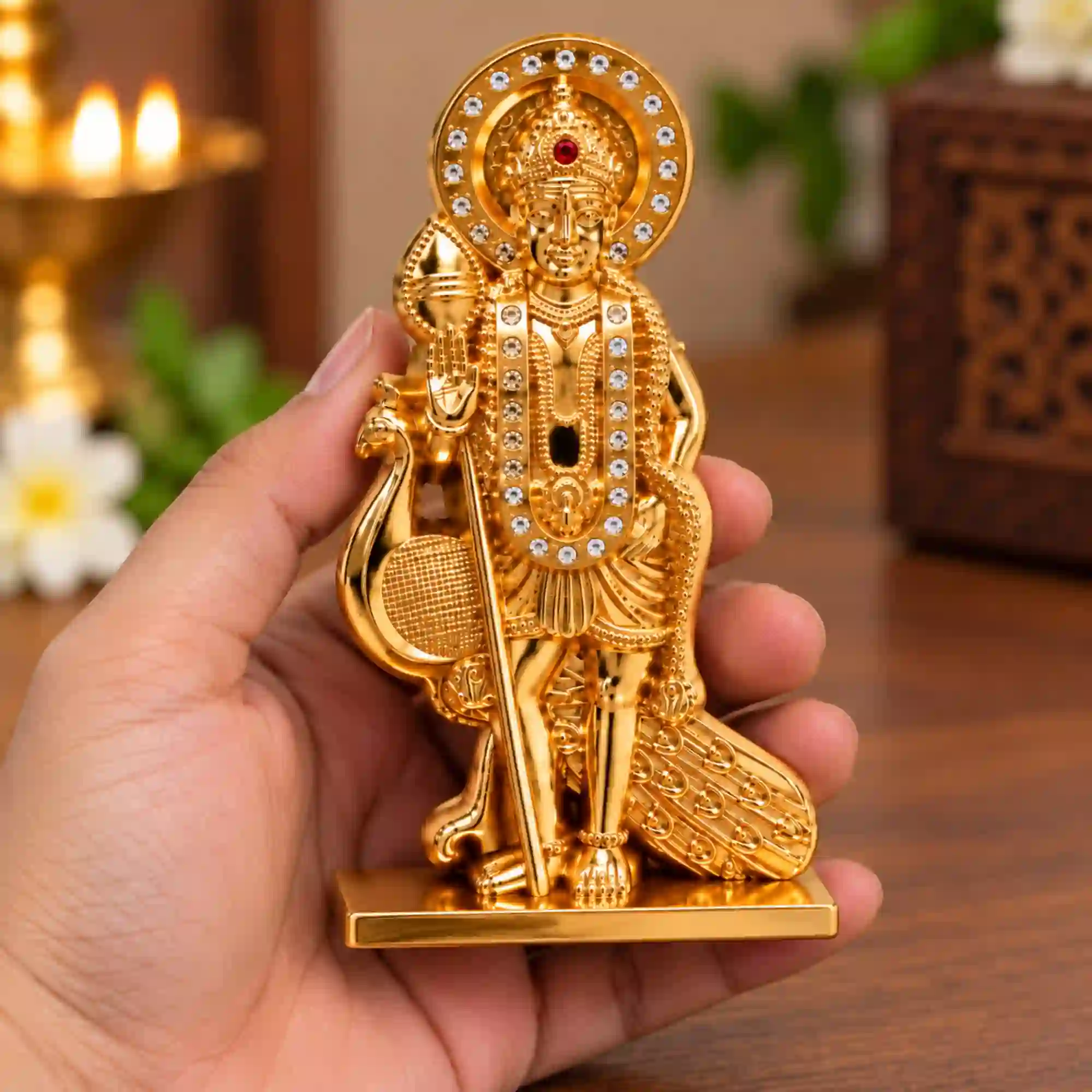 Compact Lord Murugan idol held in hand with golden finish