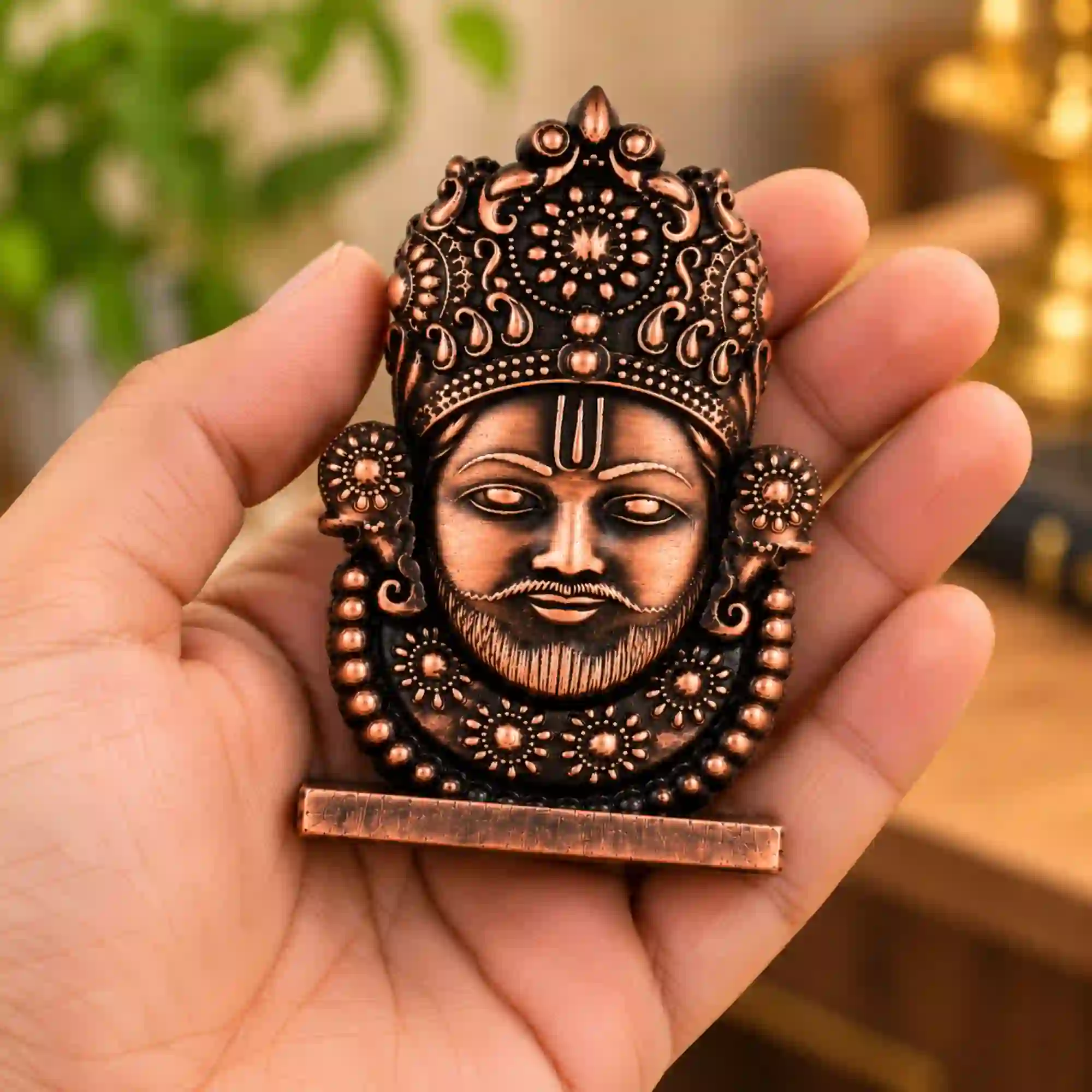 Small Khatu Shyam Ji idol held in hand showing intricate crown and antique finish